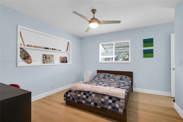 bedroom with hardwood / wood-style floors and ceiling fan