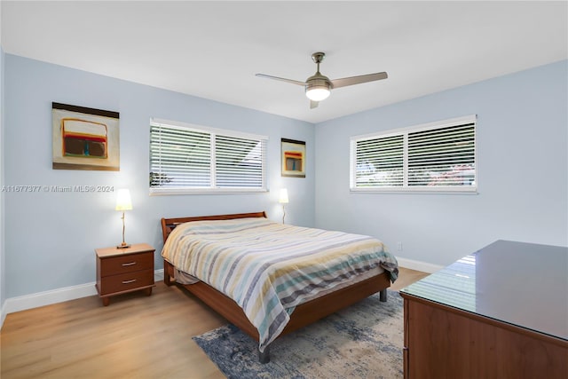 bedroom with ceiling fan and light hardwood / wood-style flooring