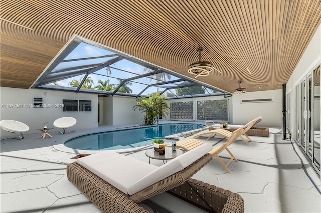 view of pool with a patio and glass enclosure