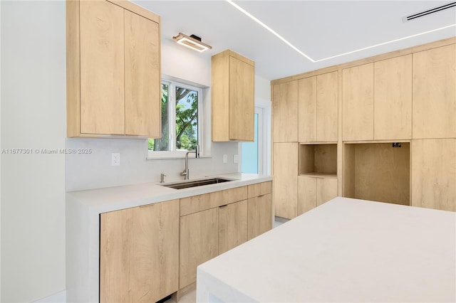 kitchen featuring sink and light brown cabinets