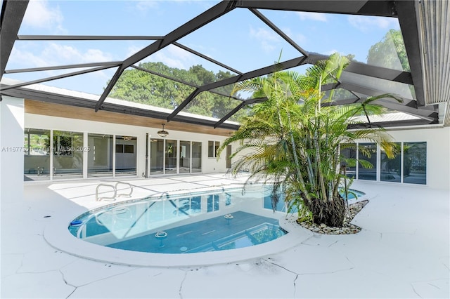 view of swimming pool featuring a patio area and glass enclosure