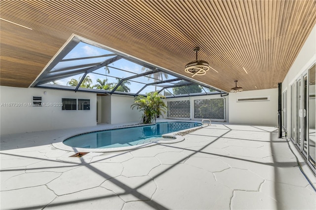 view of swimming pool featuring a lanai and a patio area