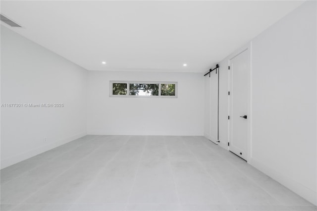 empty room featuring a barn door