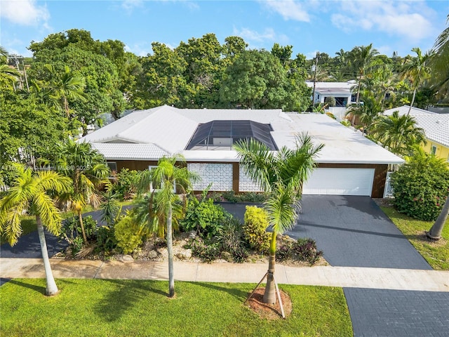 view of front of property featuring a garage and solar panels