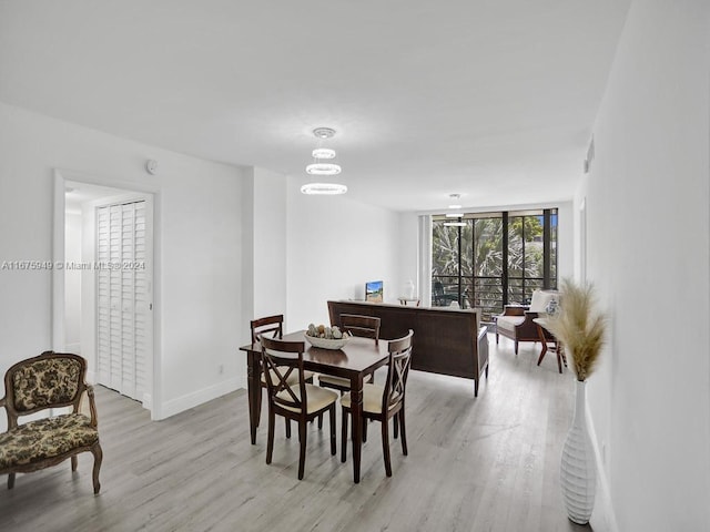 dining room with an inviting chandelier and light wood-type flooring