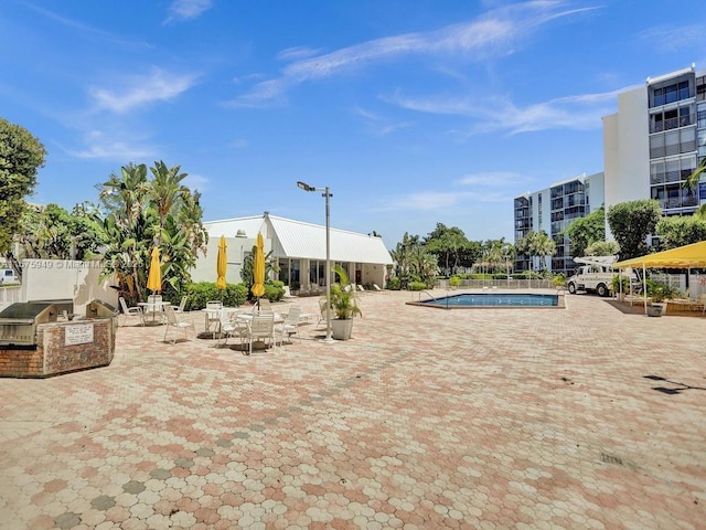 20400 W Country Club Dr Unit 301, Aventura, FL 33180 - community pool featuring an outdoor kitchen, a patio area, and grilling area