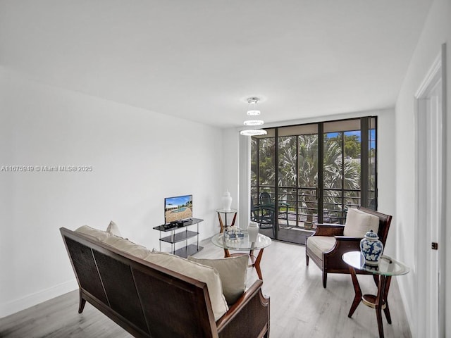 20400 W Country Club Dr Unit 301, Aventura, FL 33180 - living area with floor to ceiling windows, wood finished floors, and baseboards