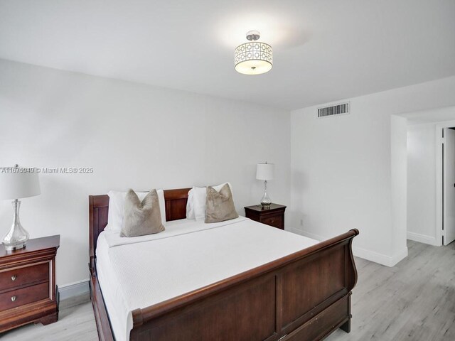 20400 W Country Club Dr Unit 301, Aventura, FL 33180 - bedroom with light wood-type flooring and baseboards