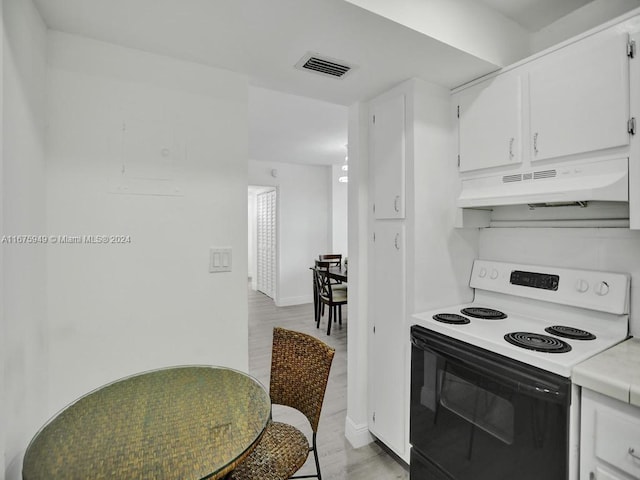 kitchen with white cabinetry, light wood-type flooring, and white range with electric cooktop