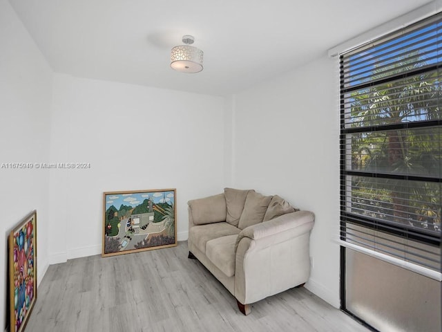 sitting room with light wood-type flooring and a healthy amount of sunlight