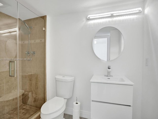 bathroom featuring vanity, toilet, and an enclosed shower