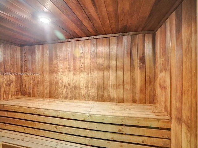 view of sauna with wood walls and wooden ceiling