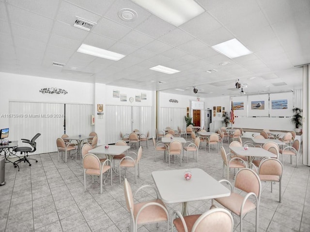 dining area featuring a paneled ceiling