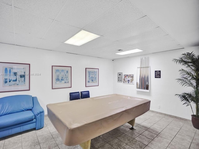 playroom with light tile patterned flooring, pool table, and a paneled ceiling