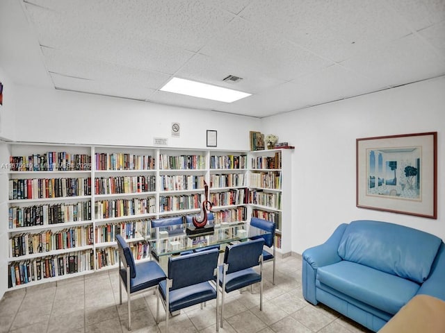 20400 W Country Club Dr Unit 301, Aventura, FL 33180 - living area with a drop ceiling, wall of books, and tile patterned flooring