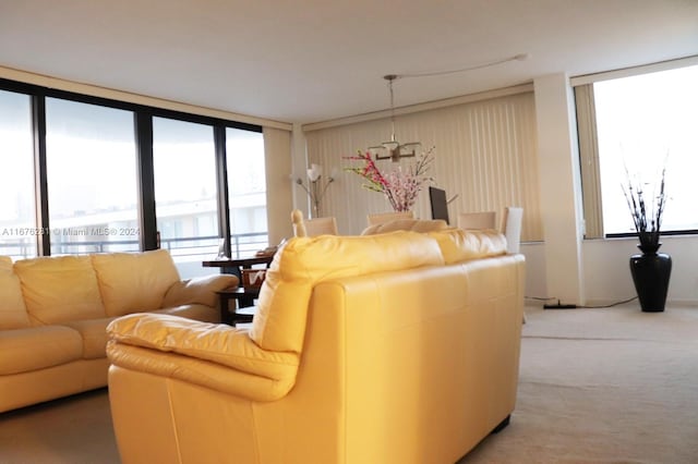 living room featuring floor to ceiling windows, carpet floors, and plenty of natural light