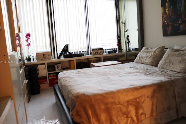 bedroom with light tile patterned floors and multiple windows