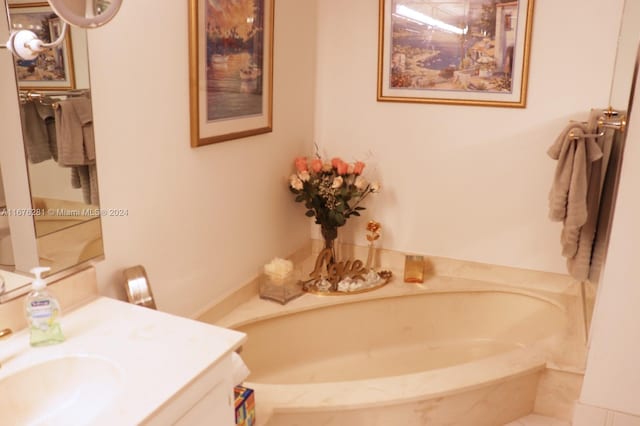 bathroom with vanity and a washtub