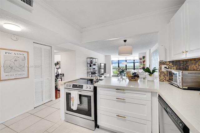 kitchen featuring light tile patterned flooring, white cabinetry, stainless steel appliances, and decorative light fixtures