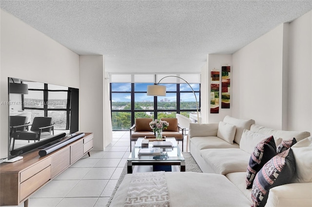 tiled living room featuring expansive windows and a textured ceiling