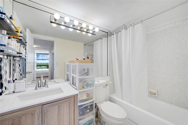 full bathroom featuring toilet, vanity, and shower / tub combo