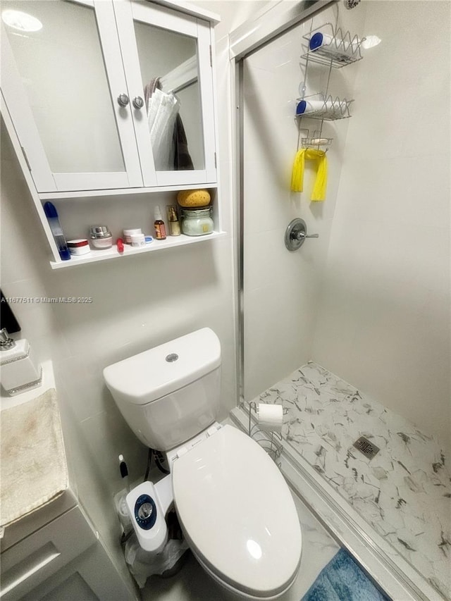 bathroom with toilet and walk in shower