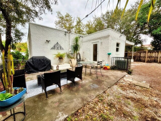 rear view of house with cooling unit, an outdoor hangout area, and a patio