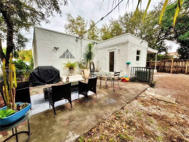 rear view of house featuring cooling unit and a patio