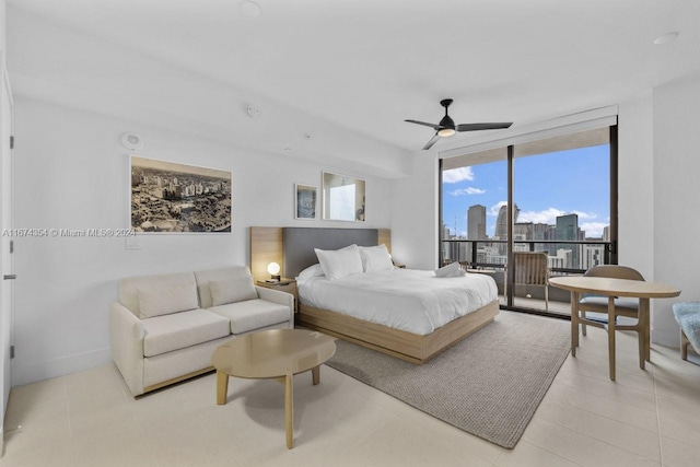 bedroom with a wall of windows, access to outside, light tile patterned flooring, and ceiling fan