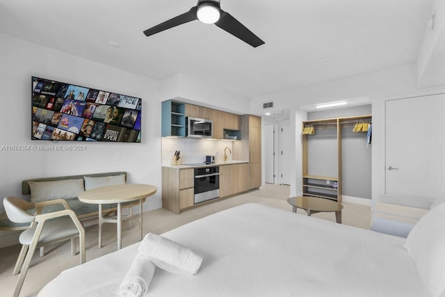 bedroom with sink, a closet, and ceiling fan