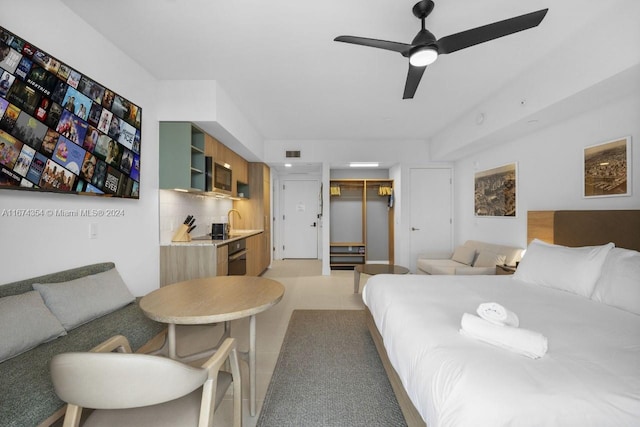 bedroom featuring a closet, a spacious closet, sink, and ceiling fan