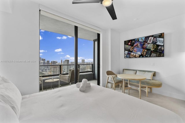 bedroom with expansive windows, tile patterned flooring, and ceiling fan