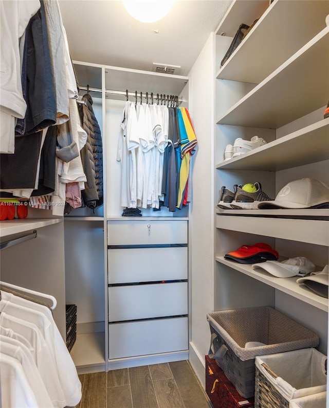 walk in closet featuring dark wood-style floors and visible vents