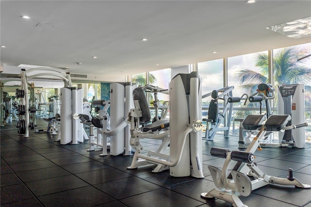 exercise room featuring floor to ceiling windows, visible vents, and recessed lighting