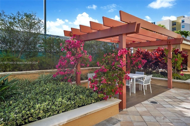 view of patio featuring a pergola and outdoor dining area