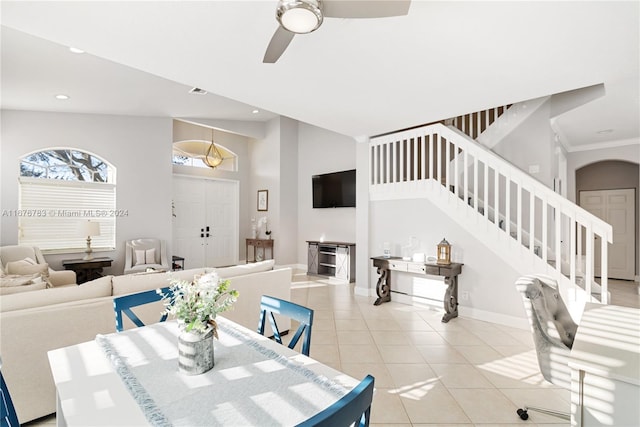 tiled dining room featuring high vaulted ceiling and ceiling fan