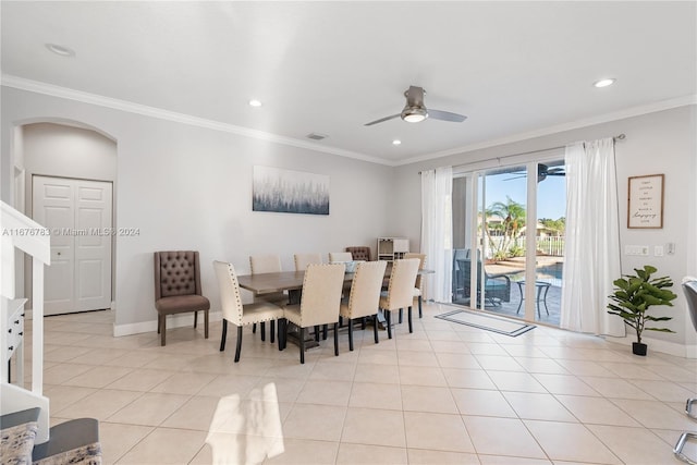 dining room with crown molding, light tile patterned floors, and ceiling fan