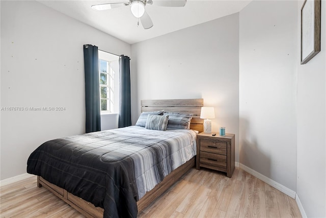 bedroom with ceiling fan, lofted ceiling, and light hardwood / wood-style flooring