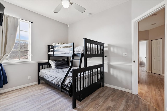 bedroom with light hardwood / wood-style flooring and ceiling fan