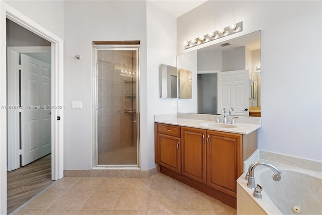 bathroom with vanity, tile patterned floors, and shower with separate bathtub