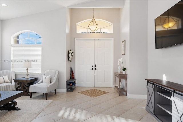 entryway featuring high vaulted ceiling and light tile patterned flooring