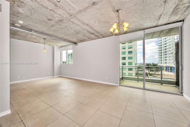 690 SW 1st Ct Unit 1730, Miami, FL 33130 - empty room featuring tile patterned floors, baseboards, a chandelier, and floor to ceiling windows