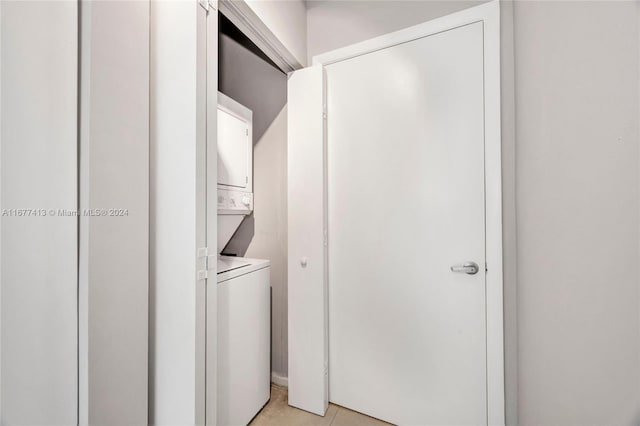 690 SW 1st Ct Unit 1730, Miami, FL 33130 - clothes washing area with stacked washing machine and dryer and light tile patterned floors