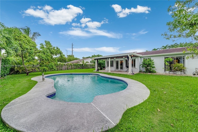 view of swimming pool featuring a yard and a patio area