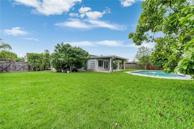 view of yard featuring a fenced in pool and a patio