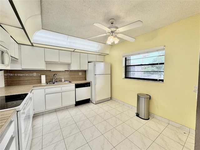 kitchen with white cabinets, ceiling fan, a textured ceiling, sink, and white appliances