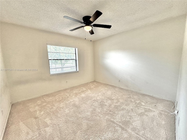 unfurnished room featuring light carpet and a textured ceiling