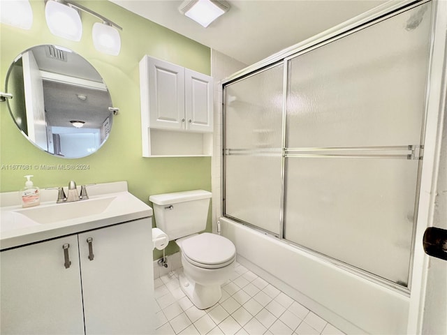 full bathroom featuring toilet, enclosed tub / shower combo, vanity, and tile patterned floors