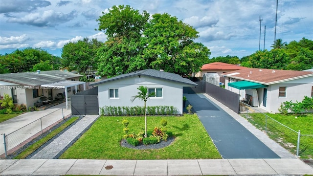 single story home featuring fence, a front yard, and stucco siding