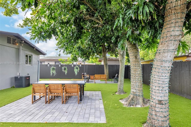 view of yard featuring a patio, an outdoor living space, and central AC